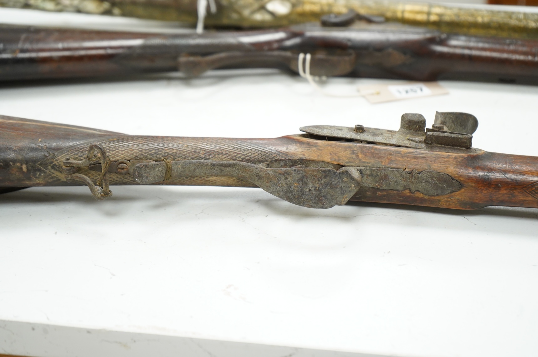 A 32 bore Continental flintlock rifle, unsigned lock, (cock missing) iron mounts and fully stocked, chequered small, sliding patch box cover, (ramrod missing)